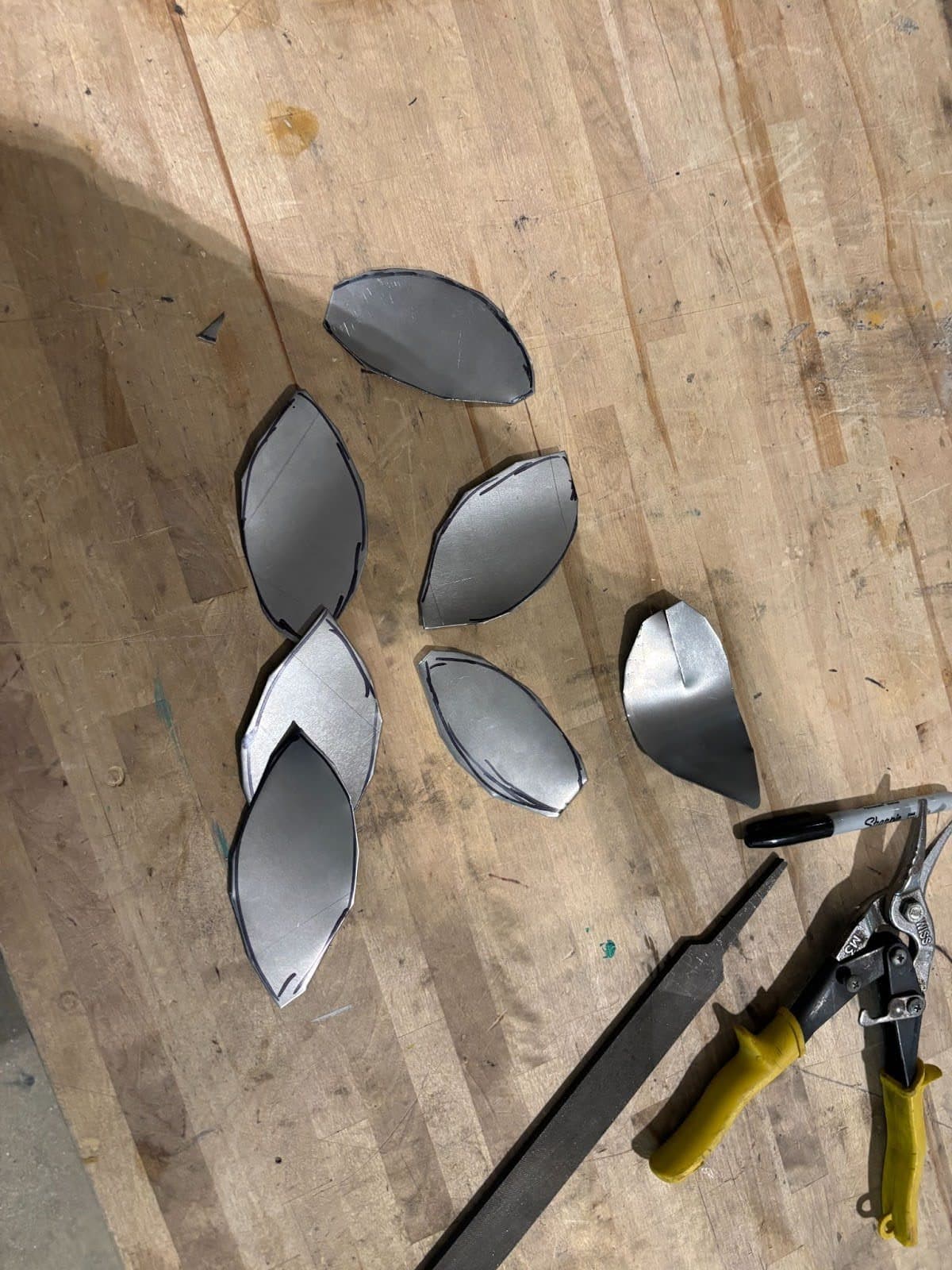 Cut metal petals with refined edges