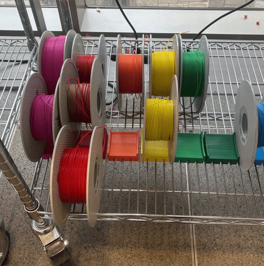 Colorful recycled 3D printing filament spools used in BloomLight