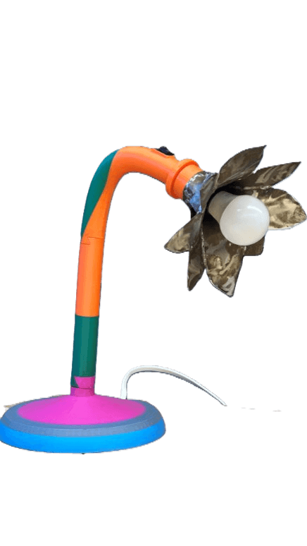 BloomLight floral desk lamp featuring metallic petal shapes on a pink 3D-printed base with an orange curved stem